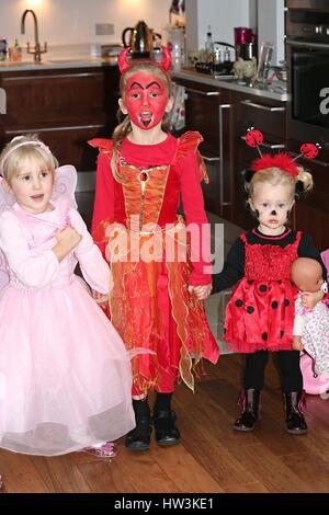 Trois filles enfants vêtus de fairy, devil et costumes ladybird habillés à l'Halloween, la peinture du visage Banque D'Images