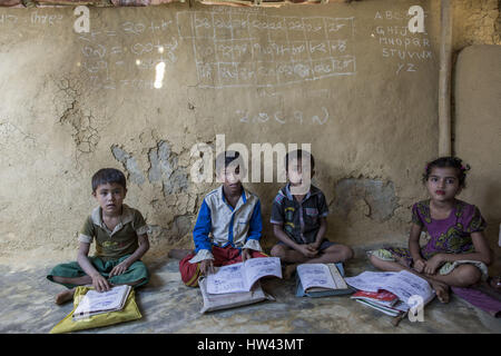 4 mars 2017 - Cox's Bazar, Chittagong, Bangladesh - enfants réfugiés rohingyas assister à une classe de l'école temporairement dans Kutapalong camp de réfugiés Rohingya le 4 mars 2017 à Cox's Bazar, le Bangladesh. Environ 70 000 Musulmans Rohingyas ont fui au Bangladesh du Myanmar depuis le 9 octobre 2016 après l'armée birmane a lancé des opérations de déminage en réponse à une attaque contre la police des frontières. Il y a plus de 30 000 réfugiés enregistrés au Bangladesh mais les autorités estiment que 300 000 à 500 000 Rohingyas non enregistrés sont également déjà vivre ici. En conséquence, la plupart de ces réfugiés non enregistrés ar Banque D'Images