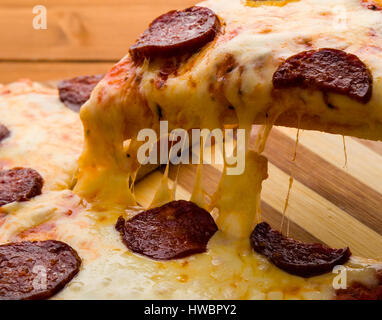 Pepperoni pizza slice close up avec du fromage et du salami Banque D'Images