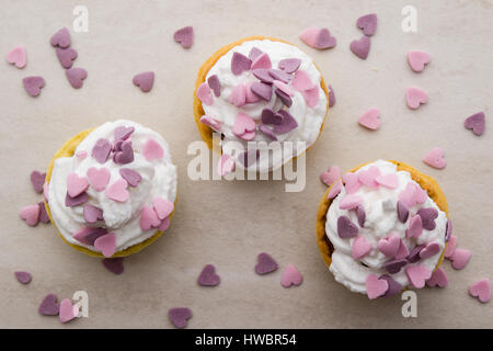 Mini tarte avec crème fouettée et ornement coeur rose Banque D'Images