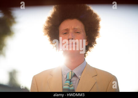 Portrait of teenage boy avec des cheveux rouges, portant costume, à l'extérieur Banque D'Images