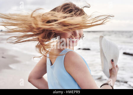 Femme cheveux balançant autour on beach Banque D'Images