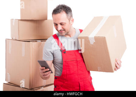 Auteur man holding box et texting on smartphone isolé sur fond blanc Banque D'Images