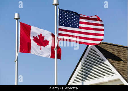 Un drapeau américain et un drapeau canadien battant côte à côte. Banque D'Images