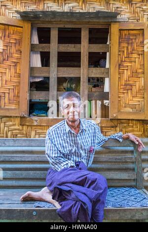 Myanmar (Birmanie), région de Mandalay, Mandalay, l'homme en face de sa maison de bambou Banque D'Images