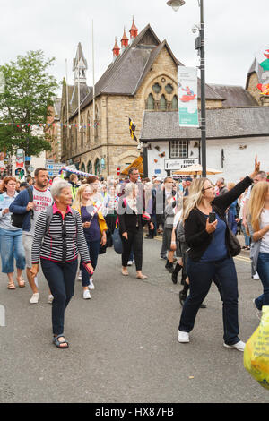 La population locale les visiteurs et les artistes de partout dans le monde prennent part à la street parade à Llangollen à l'eisteddfod International Annuel Banque D'Images