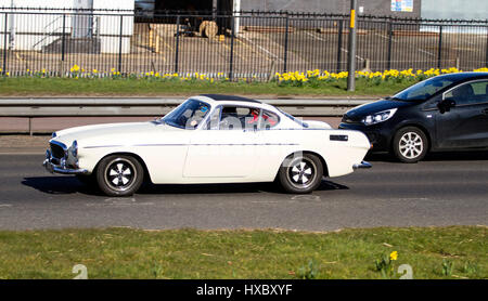 Un enregistrement de 1972 K vintage Volvo P1800 voiture de sport comme entraîné par Roger Moore se déplaçant le long de la Kingsway West à deux voies dans Dundee, Royaume-Uni Banque D'Images