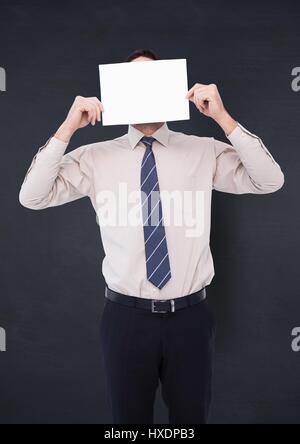 Digital composite of business man holding card sur le visage contre le tableau de la marine Banque D'Images