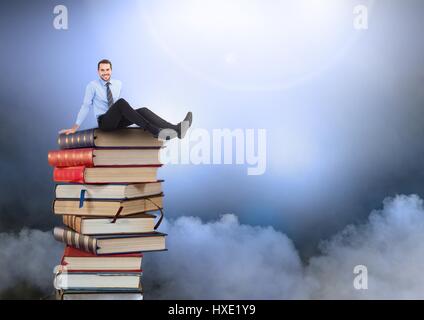 Digital composite of Businessman sitting on Books empilées par les nuages de l'atmosphère Banque D'Images