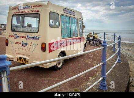 Ice cream van fauteuil roulant la baie de Morecambe. Couple retraités de manger. garde-corps Banque D'Images