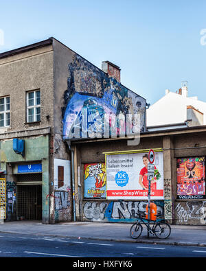 Berlin. Mitte. Entrée de Heinrich Heine U-Bahn gare souterraine dans immeuble ancien avec des affiches d'art de rue et de l'écaillement. Banque D'Images