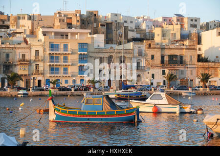 KALKARA, MALTE - 23 juillet 2015 : l'avis de Kalkara ville sur la baie avec la location de bateau traditionnel maltais (Luzzu) dans le coucher du soleil la lumière. Malte Banque D'Images