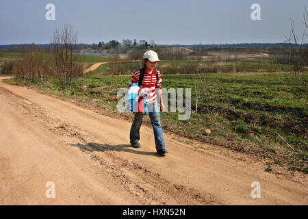 Tver, Russie - 5 mai 2006 : les zones rurales en Russie, village girl 11 ans, va d'une école rurale, la maison, sur une longue route de campagne sinueuse sur une fille Banque D'Images