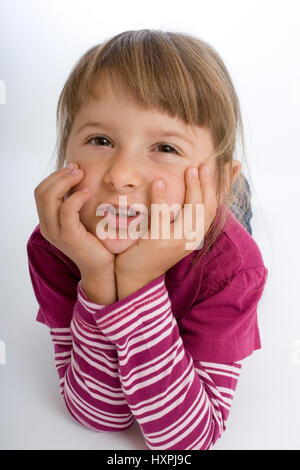 Fillette de quatre ans se trouve sur le terrain (MR), vierjähriges Mädchen liegt auf dem Boden (Mr) Banque D'Images