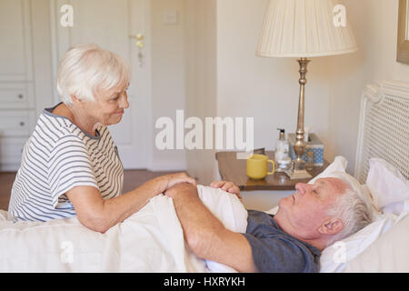 Hauts femme prendre soin de son mari malade au lit Banque D'Images