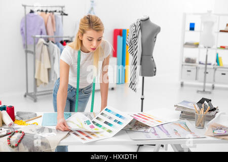 Jeune femme blonde créateur de mode de contrôle d'échantillons palette de couleurs Banque D'Images