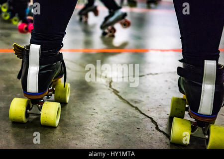 Un gros coup de patins à roulettes en tant que membre de l'équipe attend d'aller sur le terrain à la patinoire de Rat City Rollergirls à Seattle, Washington. Banque D'Images