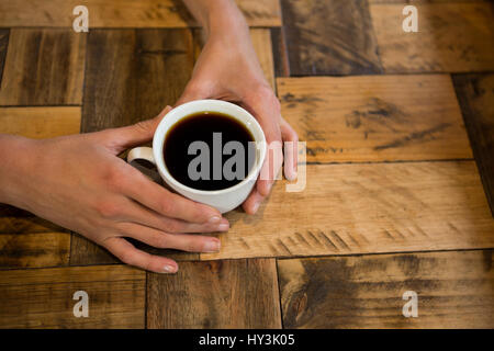 Coup de frais généraux man holding Coffee cup at table in cafe Banque D'Images