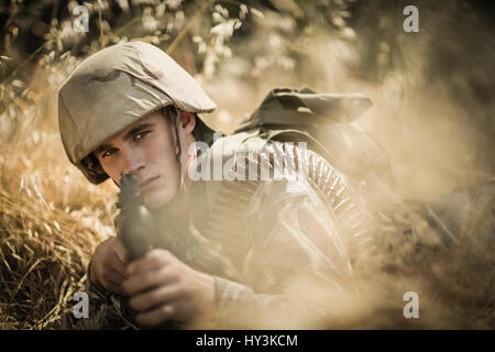 Portrait de soldat militaire visant avec un fusil dans boot camp Banque D'Images