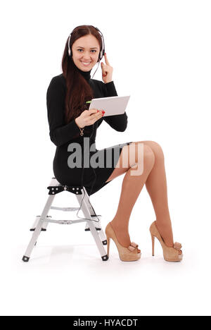 Happy student teenage girl sitting on l'échelle avec tablet pc at headphones isolated on white Banque D'Images