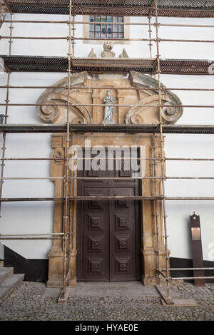 Obidos, Portugal : Façade de l'Igreja da Misericórdia couverts par un échafaudage alors qu'en rénovation. Dans une niche au-dessus de la porte vitrée est une stat azulejo Banque D'Images