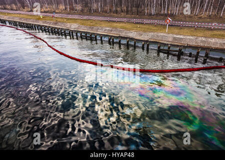 La flèche d'huile flottante avec déversement de pétrole dans l'eau - la pollution de l'environnement. Banque D'Images