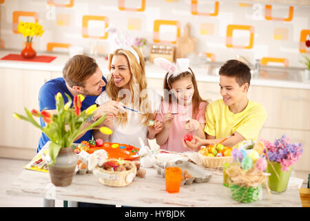 Famille heureuse ensemble dans les oeufs de Pâques coloriage cuisine Banque D'Images