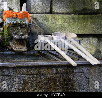 Fontaine de purification Chozuya louches. Shinto japonais traditionnel lavabo rituel pour cleaningof fidèles au culte d'entrée. Banque D'Images