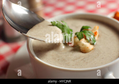 Bol de soupe crème de champignons avec champignon sur table Banque D'Images