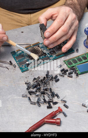 Réparer la carte graphique. Dévisser le ventilateur de refroidissement. Service sur un ordinateur.service de nettoyage brosse soufflante sur circuit intégré. Banque D'Images