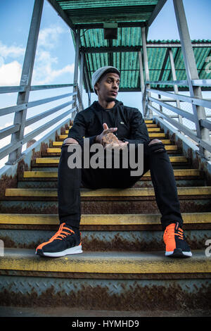 Un portrait d'une jeune hipster la saisie d'un au-dessus du sol station de métro à Brooklyn, New York. Tourné au cours de l'automne 2016. Banque D'Images