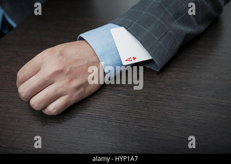 Man's hands close up, masquer un as dans un manchon Banque D'Images