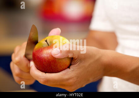 Close up female hands trancheuse couteau avec Apple Banque D'Images