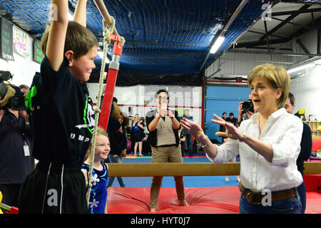 Premier ministre et leader du SNP Nicola Sturgeon observe une jeune gymnaste sur sa routine sur une visite d'une campagne pour l'gymnastic club à Cumbernauld Banque D'Images