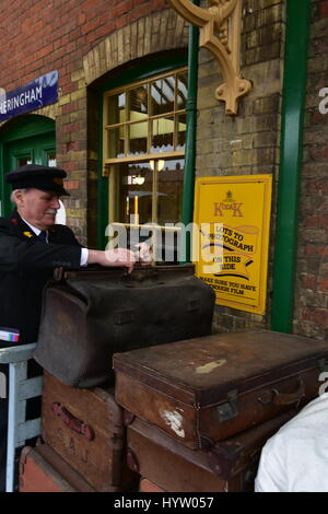 Chef de station de la plate-forme ou porter les bagages de tri à Sheringham station de la gare North Norfolk Banque D'Images