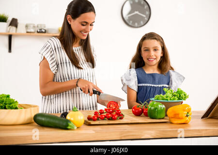 Tourné d'une mère et sa fille s'amuser dans la cuisine Banque D'Images