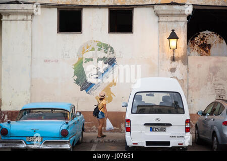 Une personne à la recherche de Che Guevara graffiti sur le côté d'un immeuble le long du Malecon dans la Vieille Havane, Cuba. Banque D'Images