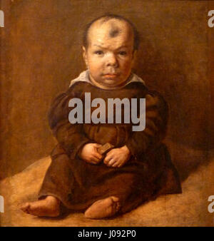 Cette peinture, attribuée à l'« Ecole de Goya », représente un nain assis, incarnant le style distinctif de l'école de Francisco Goya au XIXe siècle. Banque D'Images