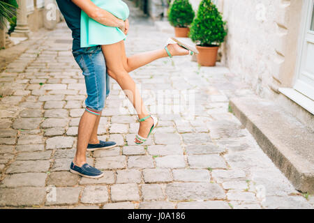 Le marié a levé la mariée dans ses bras. Les jambes de près. Je mariage Banque D'Images