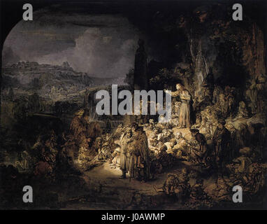 « La prédication de Saint Jean » de Rembrandt est une scène biblique représentant Saint Jean Baptiste délivrant son message. L’utilisation magistrale de la lumière et de l’ombre par Rembrandt renforce le drame et l’intensité du moment, caractéristiques de son style. Banque D'Images