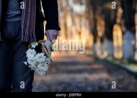 L'homme en attente sur un banc la date in autumn park Banque D'Images