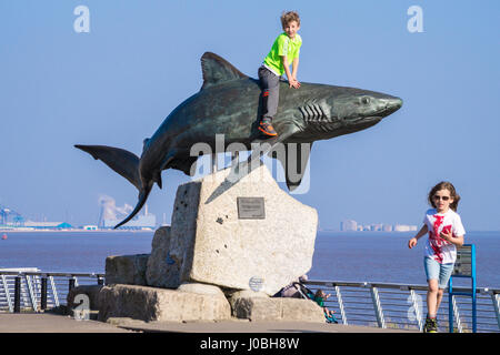 Petit garçon assis sur "requin", sculpture en bronze de requins gris de récif par Christopher Kelly, 2002, l'aquarium The Deep, Kingston-upon-Hull, Yorkshire, Angleterre Banque D'Images