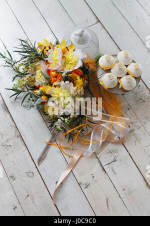 Beaux gâteaux et bouquet de mariée dans les tons orange Banque D'Images