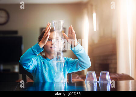 Girl stacking des gobelets en plastique Banque D'Images