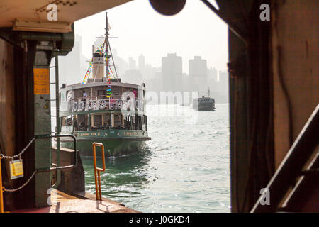 Le Star Ferry, qui vient s'amarrer à l'île de Hong Kong Kowloon avec en arrière-plan sur le port Victoria Harbour Ferry Star voyage l'île de Hong Kong Banque D'Images