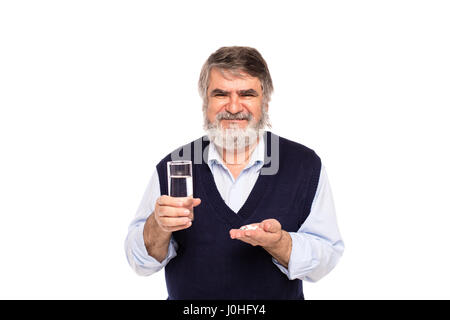 Vieil homme à barbe grise avec un verre d'eau et de comprimés dans les mains, isolated on white Banque D'Images