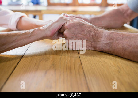 Romantic senior couple holding hands in outdoor cafÃƒÂ© Banque D'Images