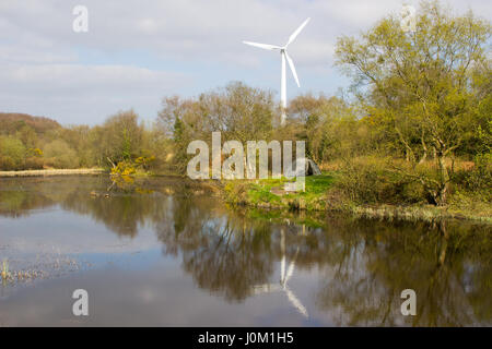 Une tente de deux hommes sur un bout de terre à côté du lac, dans l'ancien fonctionnement des mines de plomb à Conlig, avec une éolienne dans le contexte Banque D'Images