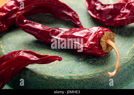 Close up de piments rouges séchés sur une plaque en céramique Banque D'Images