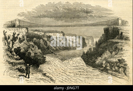 1854, gravure ancienne 'Vue sur le pont suspendu, Niagara.' Le pont suspendu de Niagara Falls, qui était de 1855 à 1897 de l'autre côté de la rivière Niagara, fut le premier pont suspendu de fer. Il s'étend sur 825 pieds (251 m) et se tint 2.5 miles (4.0 km) en aval des chutes du Niagara, où elle relie Niagara Falls (Ontario), à Niagara Falls, New York. SOURCE : gravure originale. Banque D'Images